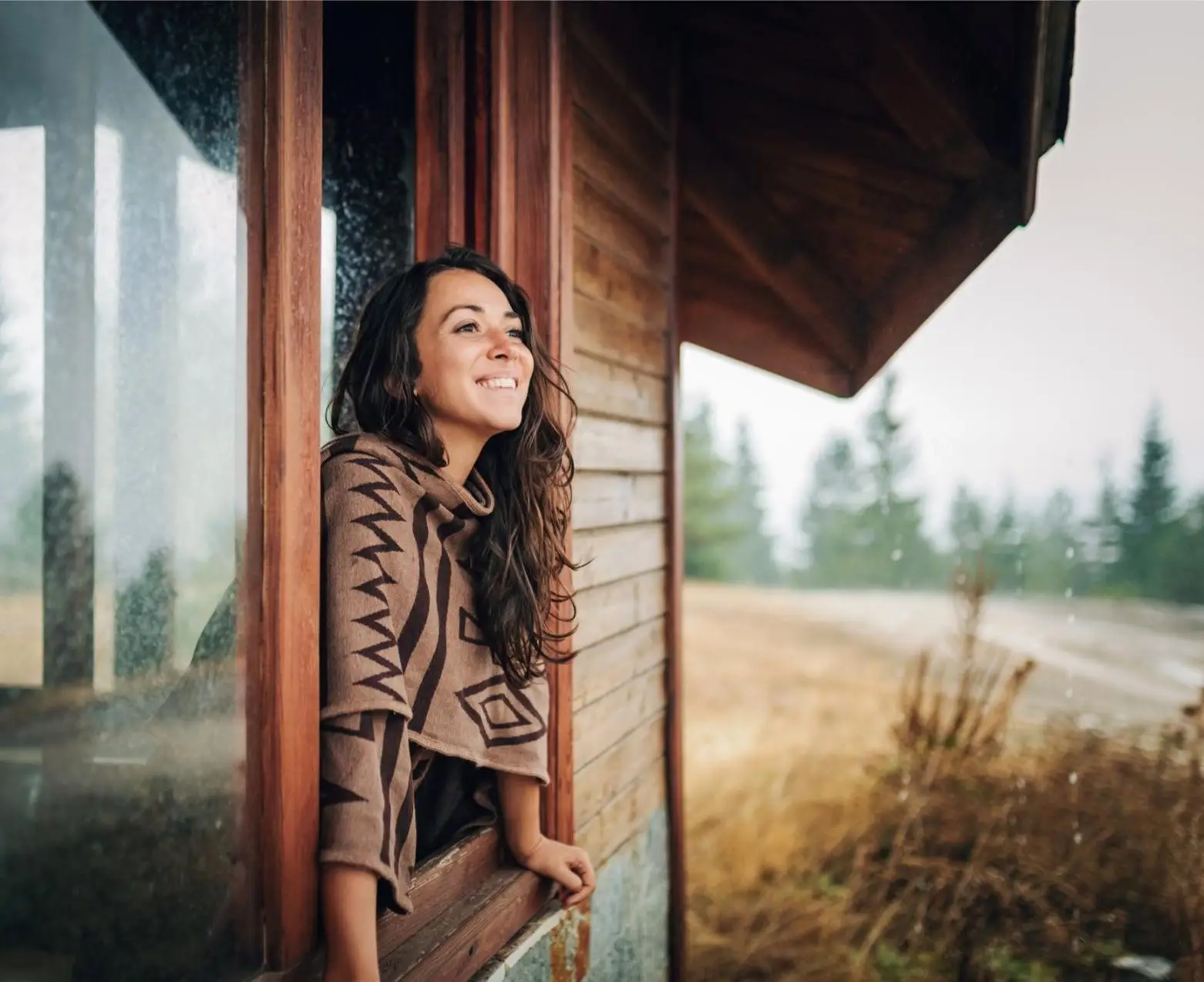 Young hippie woman enjoying a cold autumn day in the mountain.