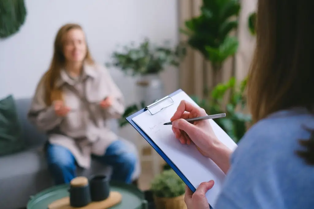Therapist supporting a client through chronic pain counselling