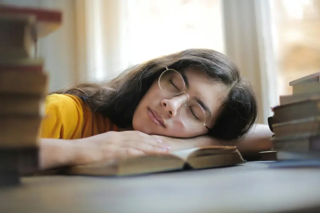 A person asleep on an open book.