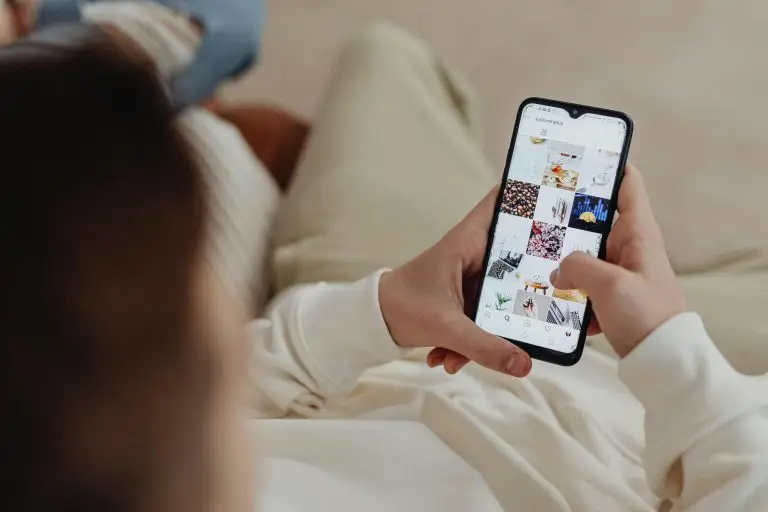 Person scrolling through a photo feed on a smartphone.