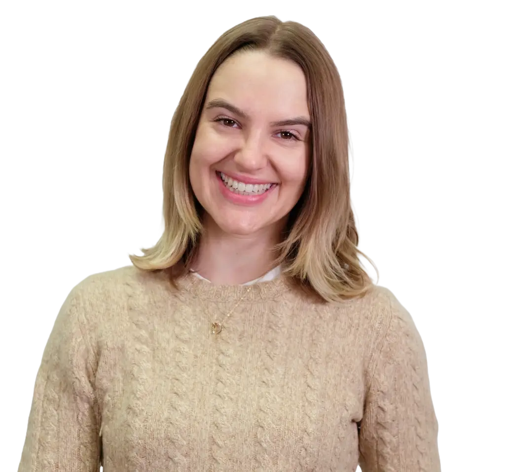 Zoomed in headshot of Annie. She's smiling and wearing a cream sweater.