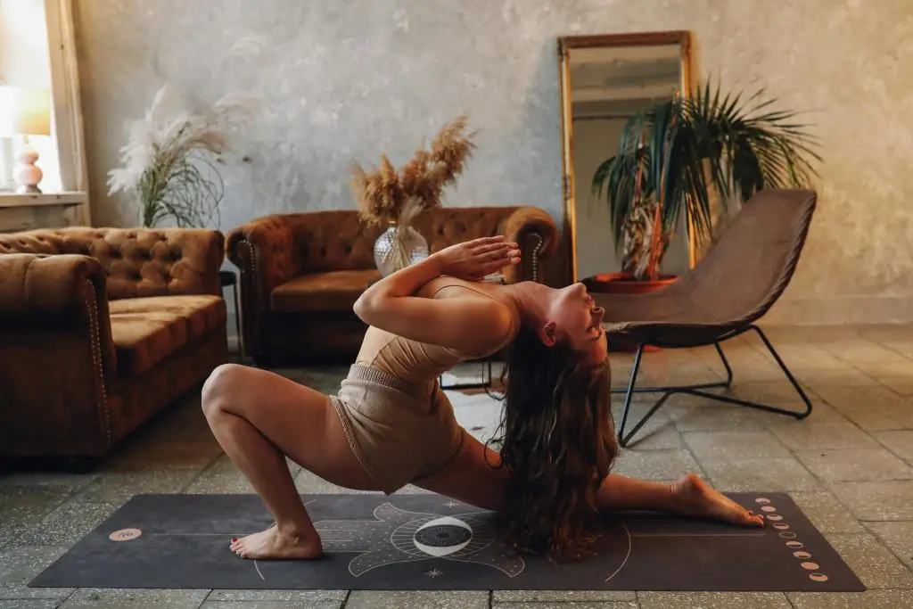 Woman engaging in somatic therapy through yoga