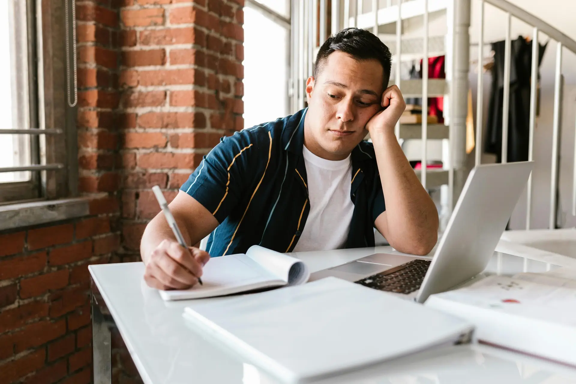 Young man looking bored at his job