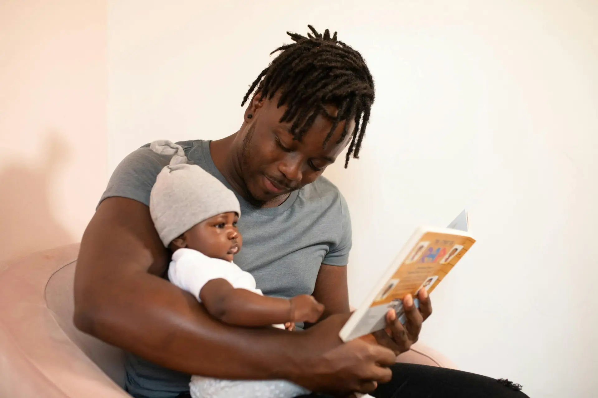 parent reading book with their child