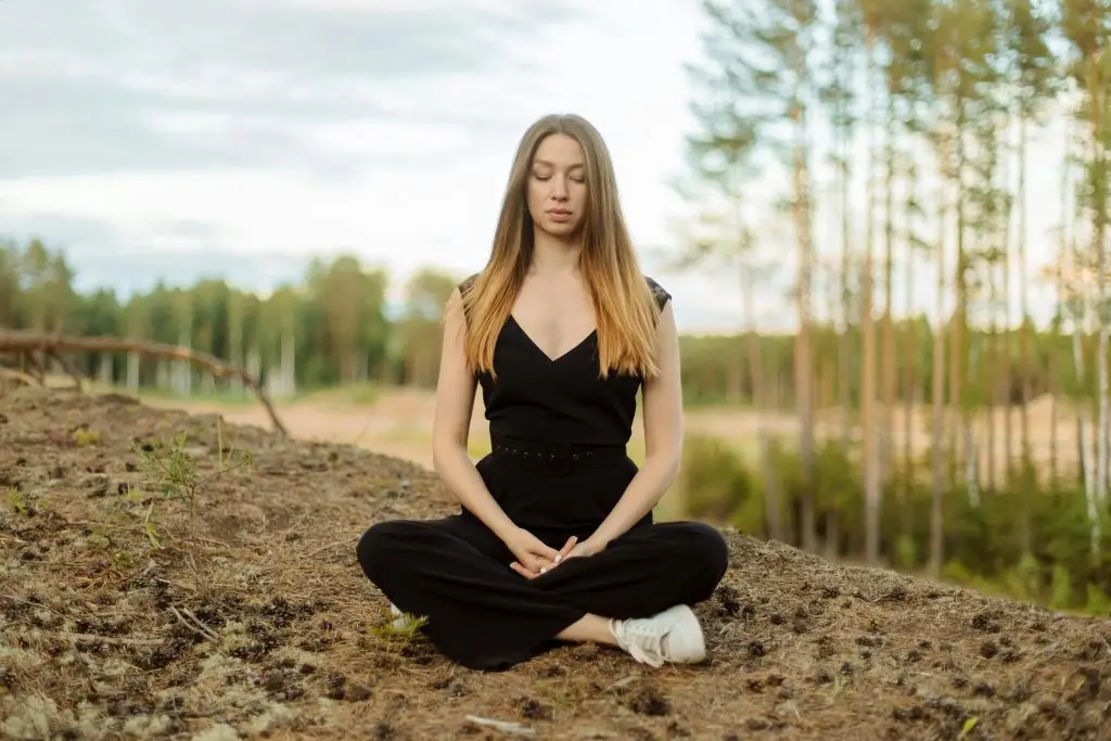 woman meditating outdoors